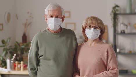 Portrait-of-Senior-Couple-in-Protective-Masks-at-Home